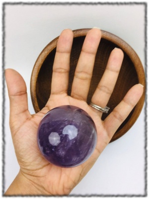 Eye of the Beholder amethyst sphere in hand.jpg